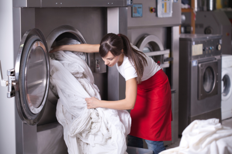 Woman loading laundry into machine